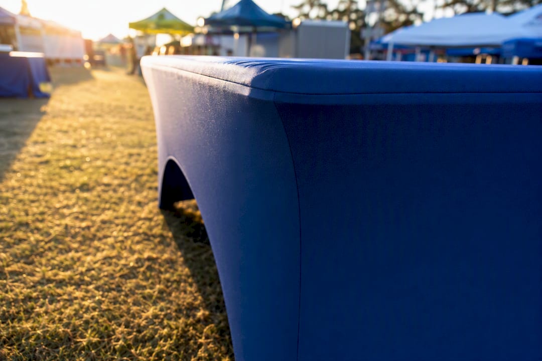 Custom-fitted fabric table cover on L-shaped table