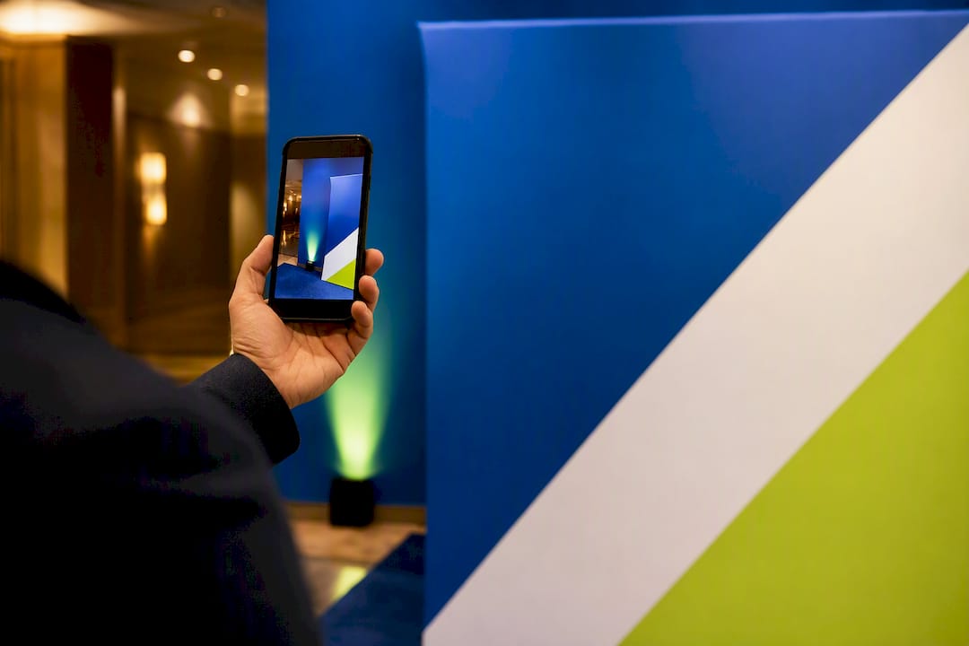 Phone photographing a cropped event backdrop