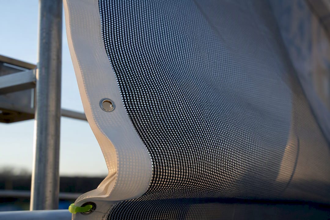 Mesh banner edge flexing in wind