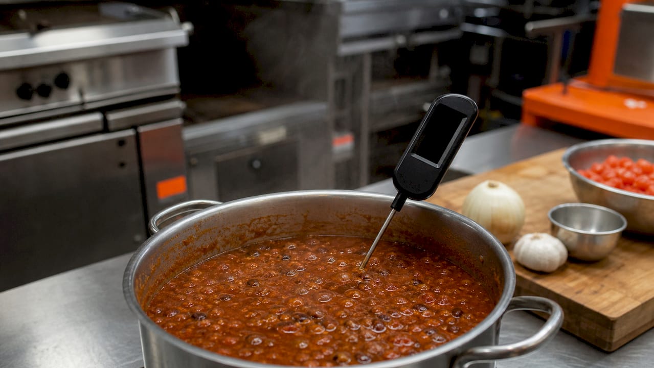 Thermometer measuring soup temperature