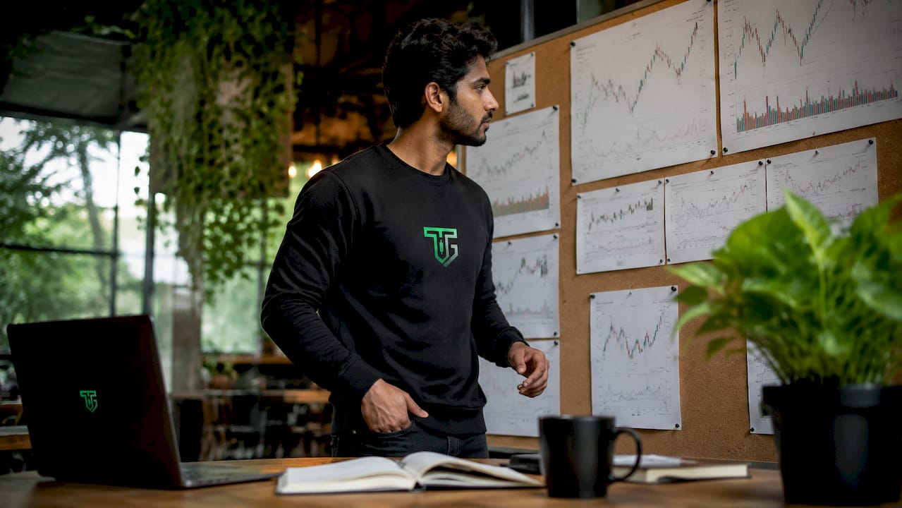 Trader studying printed market charts in home office