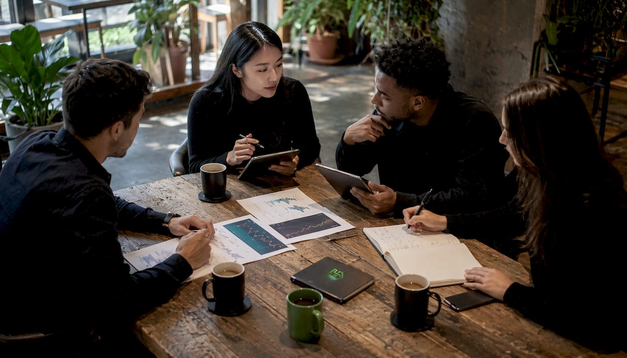 Small trading pod in focused discussion