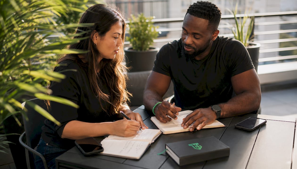 Two traders reviewing journal together