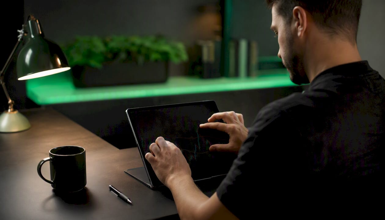 Trader marking breakout levels on digital tablet