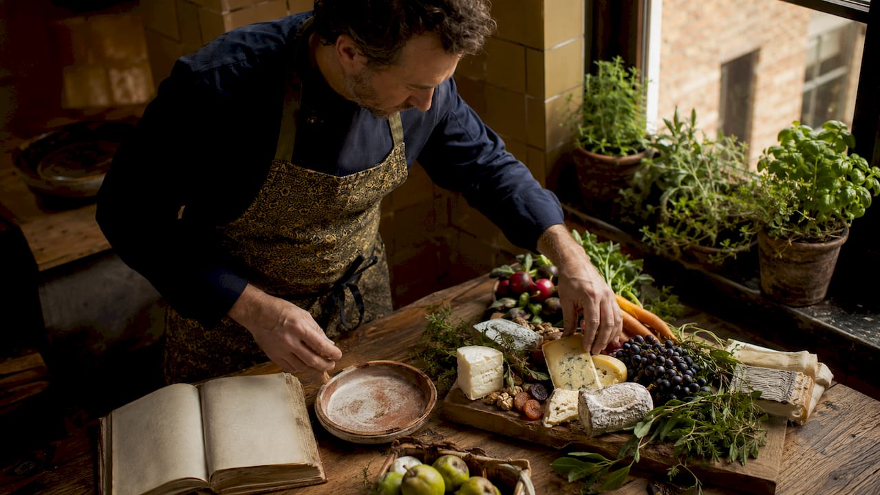 Chef arranging local artisanal produce in kitchen