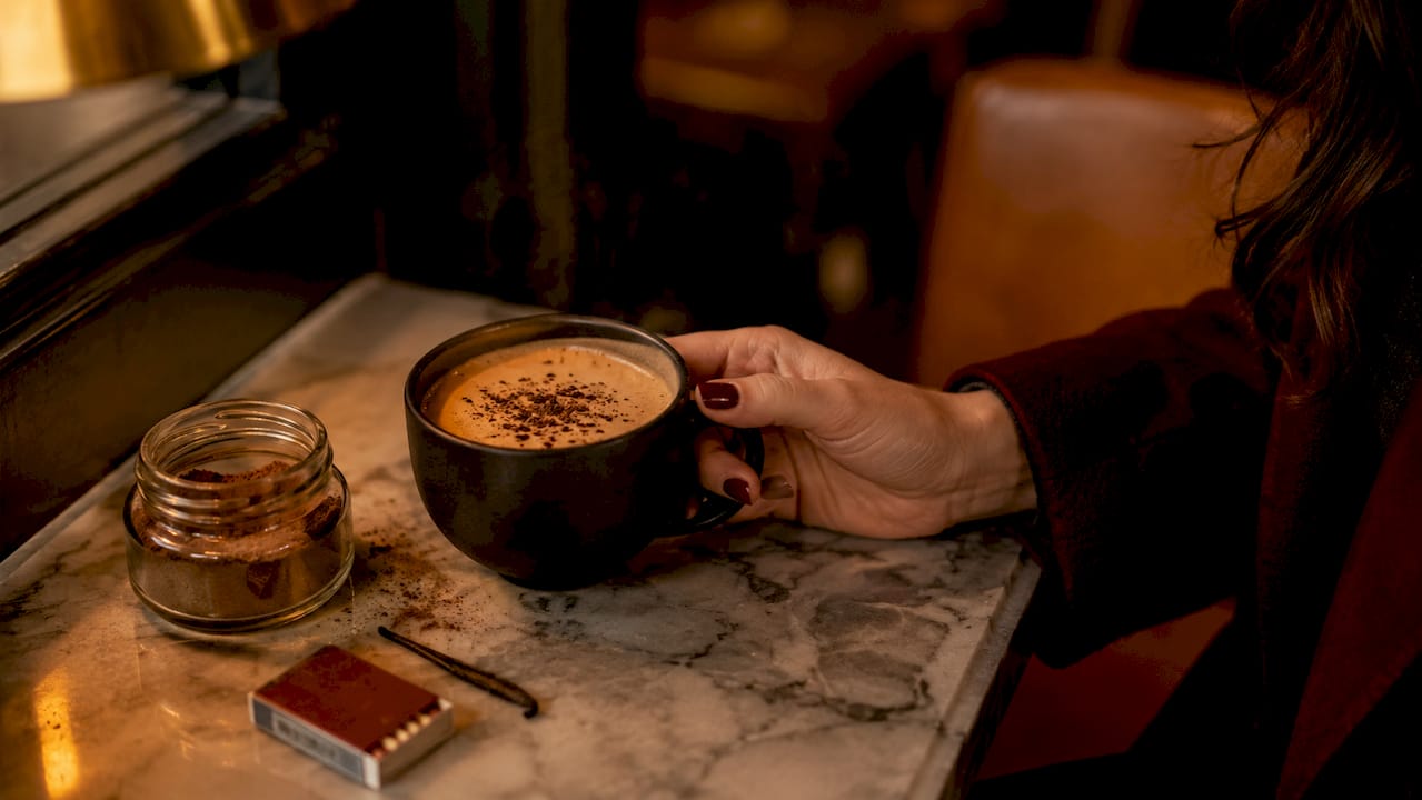 Close-up of Irish cream coffee cup with flavor elements