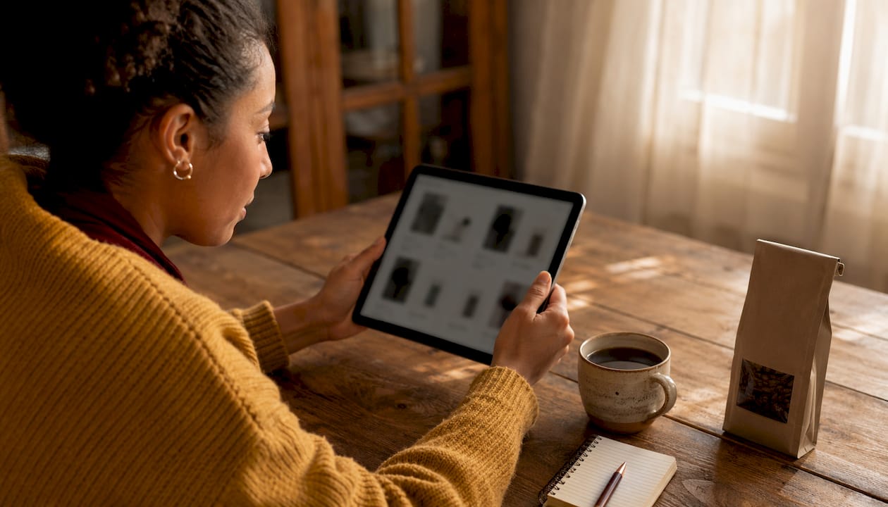 Hands browsing specialty coffee beans on tablet