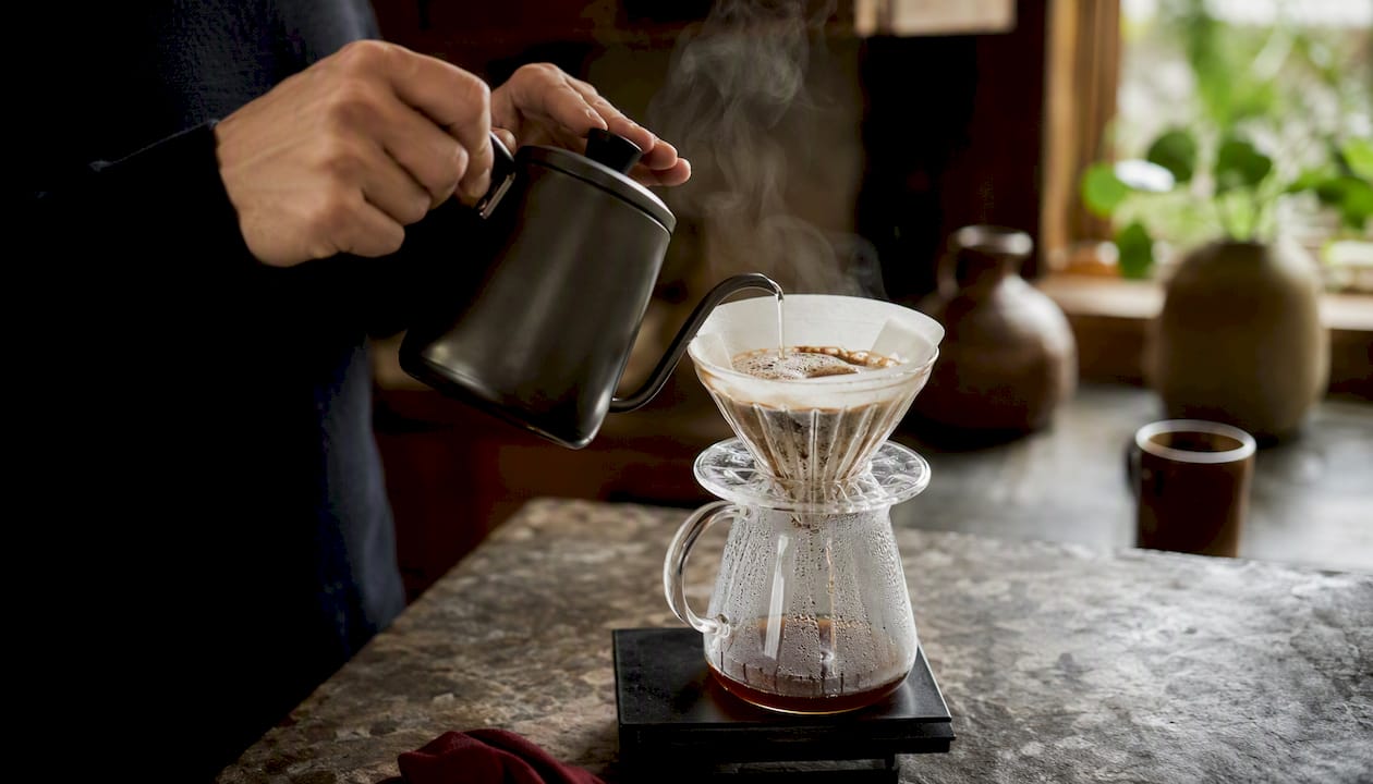 Close-up coffee pour-over bloom during break