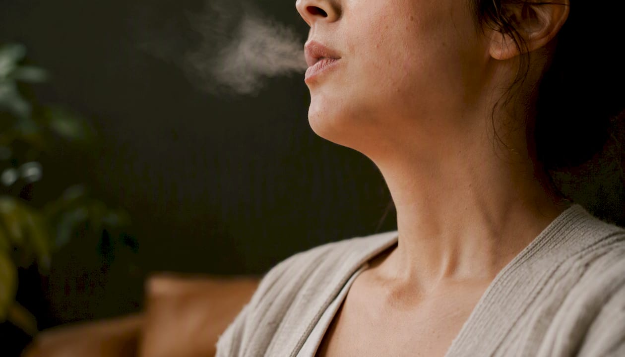 Close-up of neck during slow exhalation