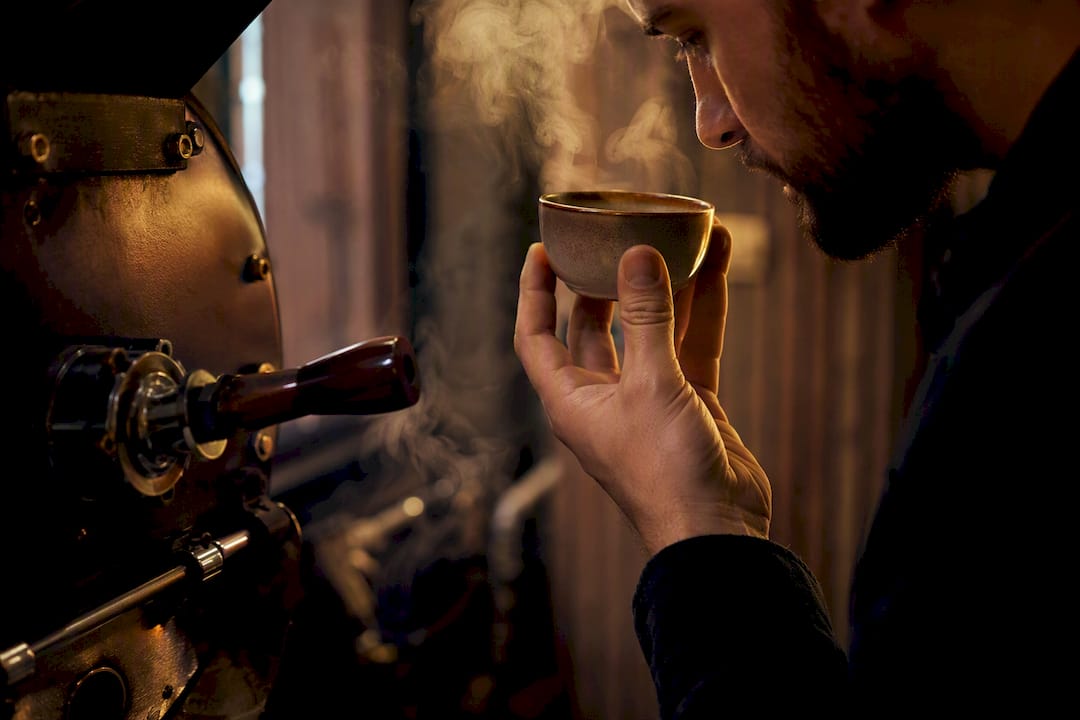 Hand smelling roasting exhaust vapor