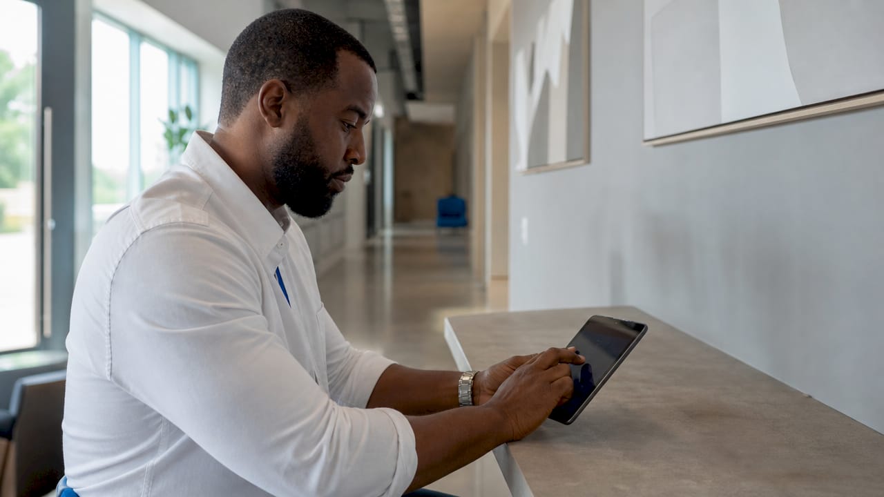 Hands entering clinical data on tablet