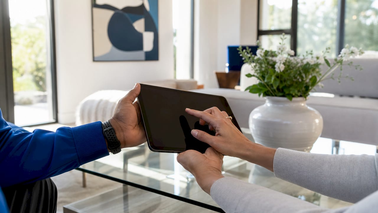 Close-up of hands setting up devices for telehealth visit