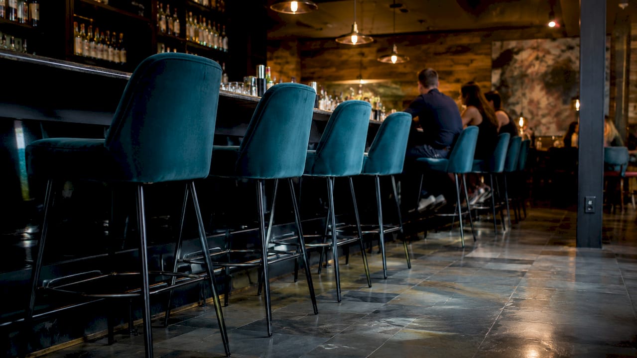 Leather bar stools in busy restaurant interior