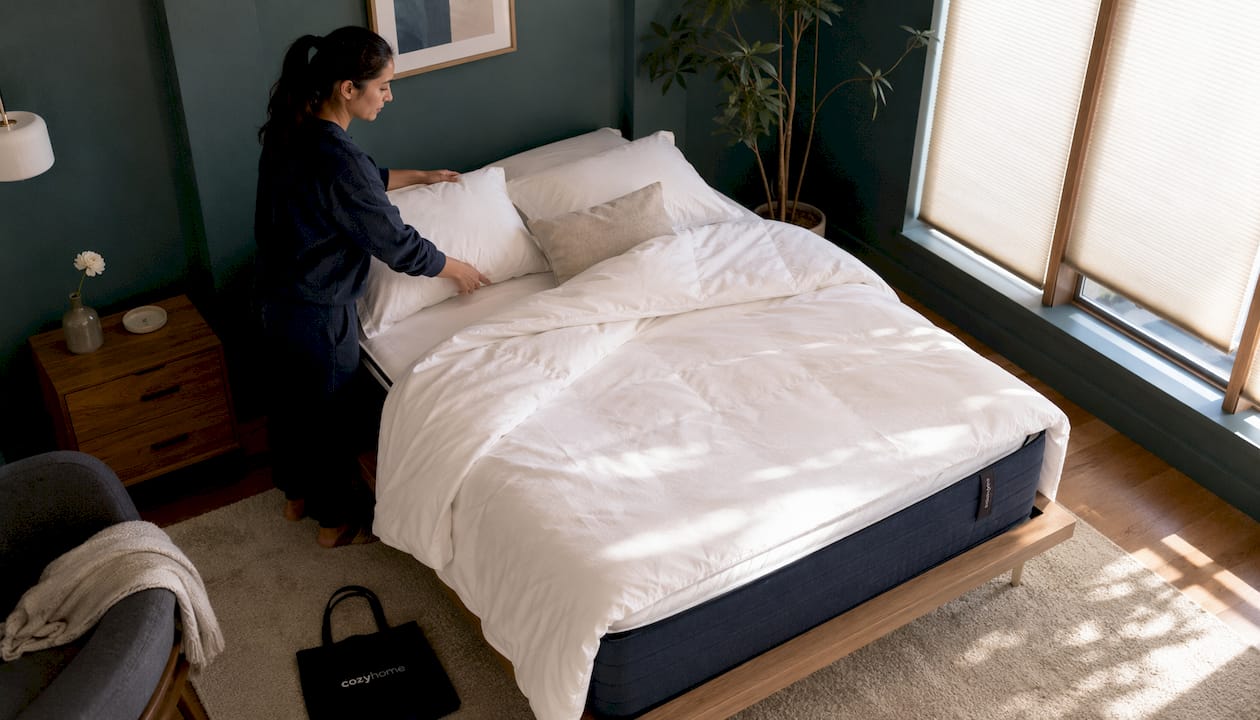 Woman making bed with flippable hybrid mattress