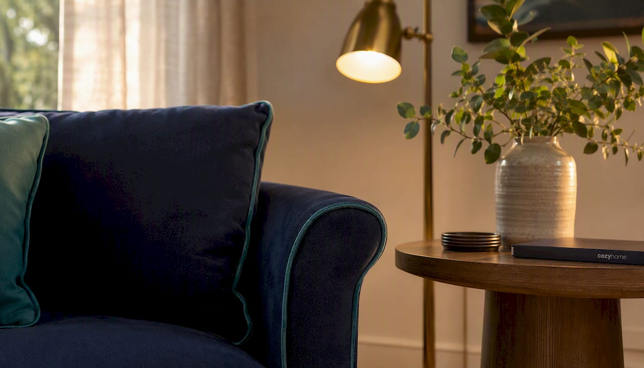 Navy velvet sofa with teal contrast welt detail