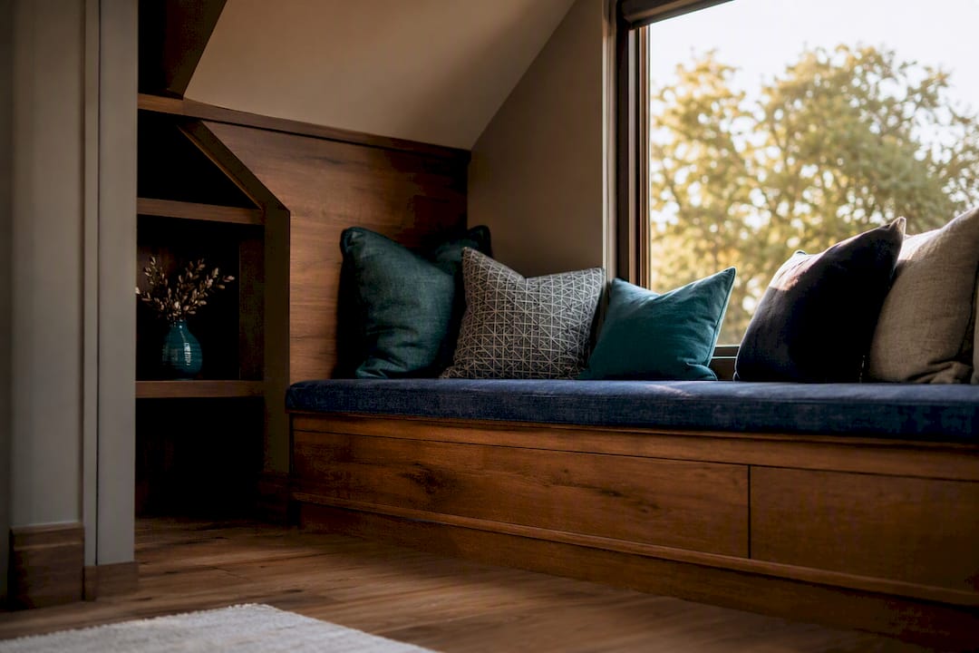 Custom bench fitting angled alcove under slope