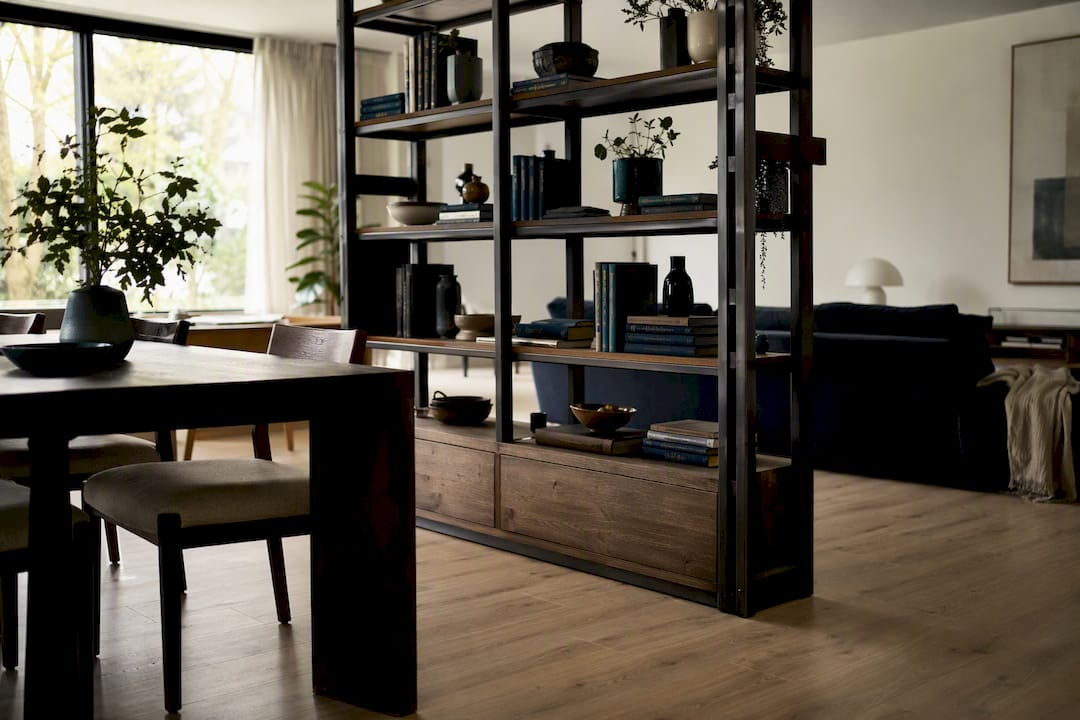 Freestanding bookshelf dividing living and dining zones
