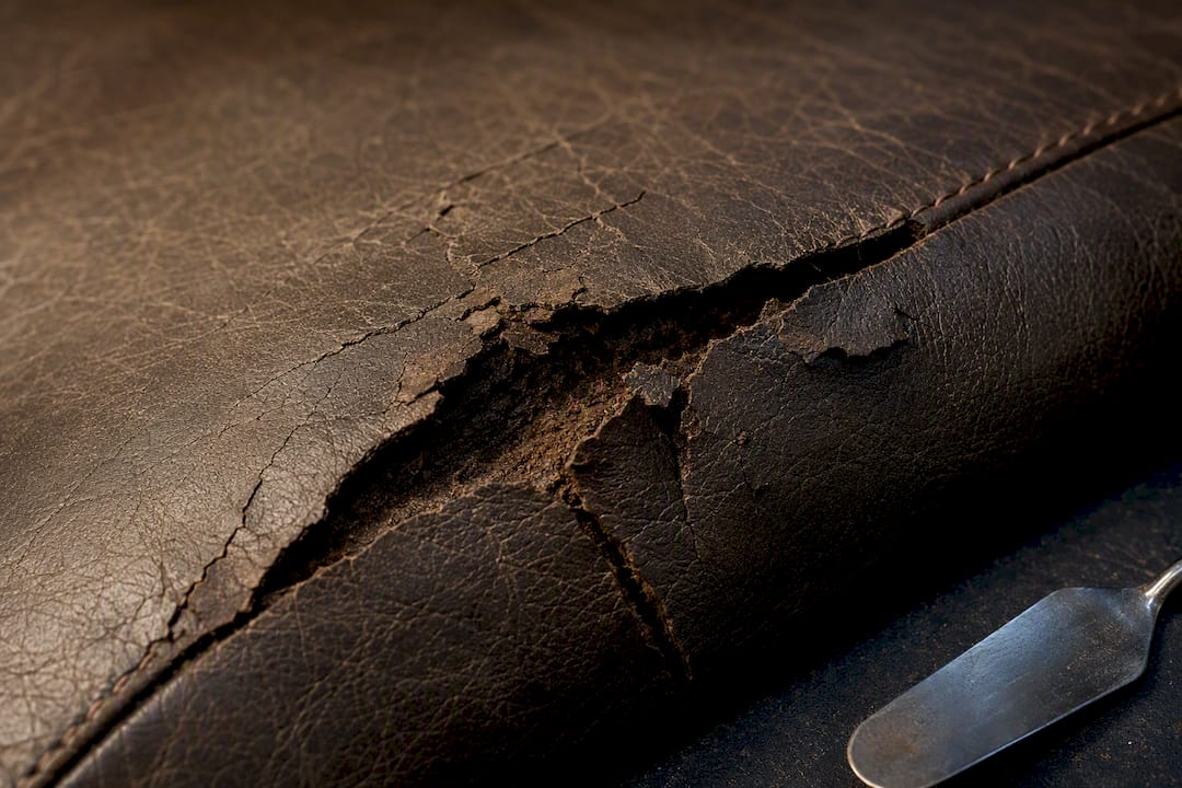 Deep crack and seam tear in leather