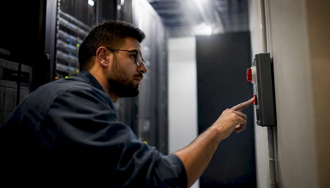 IT team member pressing alert button