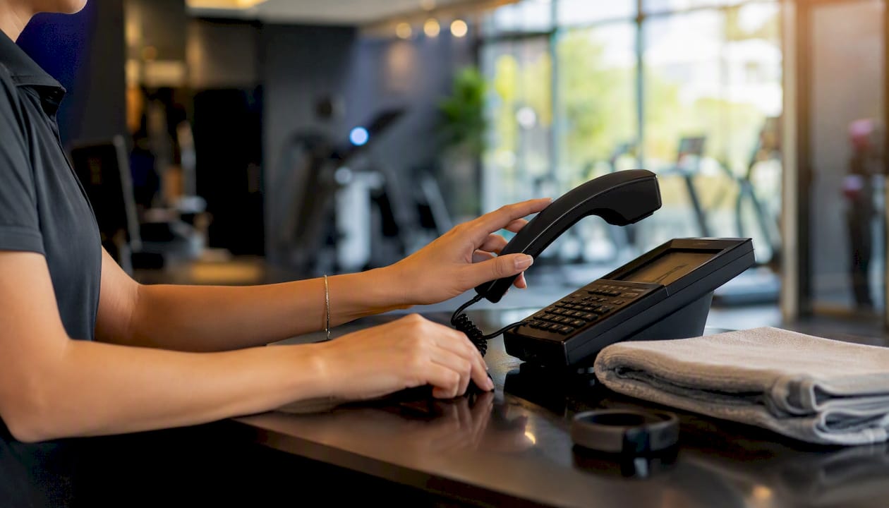Gym receptionist answering phone call
