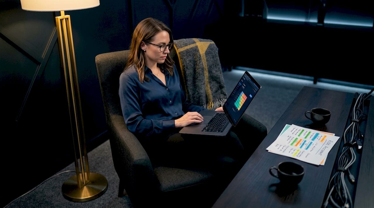Woman analyzing crypto risk on laptop at home