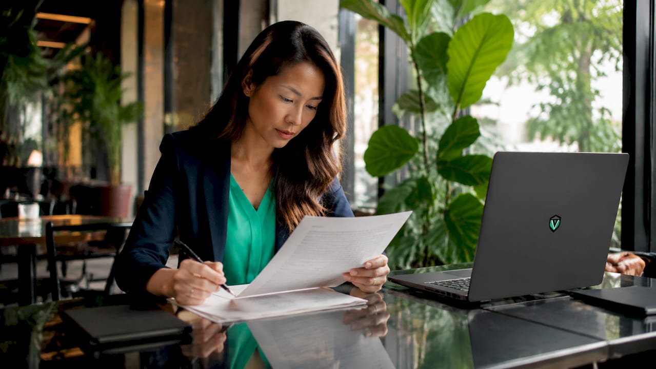 Person reviewing franchise agreement documents at desk