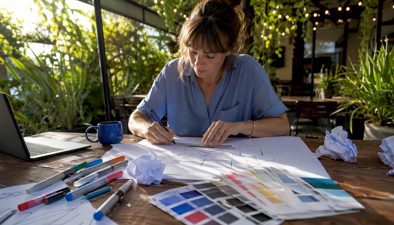 Designer sketching political sign layout at desk