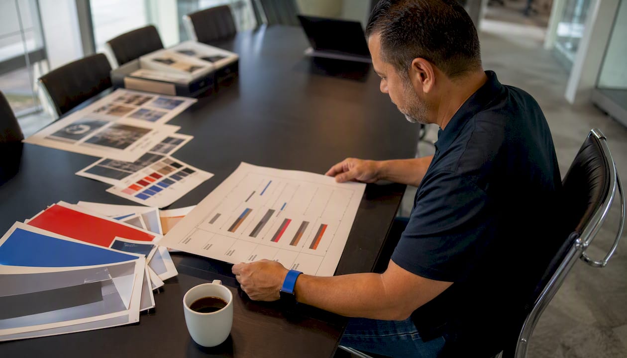 Man reviewing sign production schedule in office