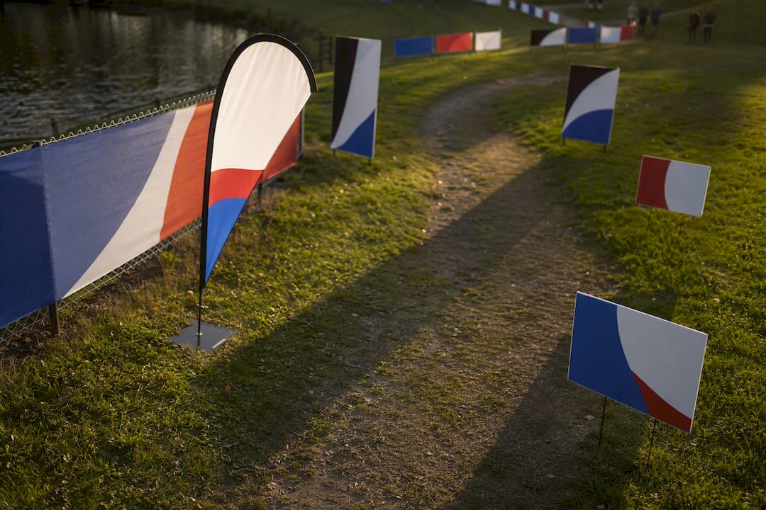 Mixed outdoor sponsor sign types displayed at event entrance