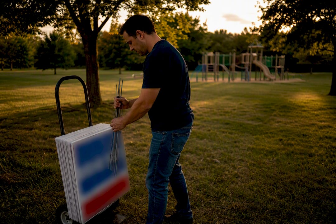 Campaign worker placing yard signs outdoors
