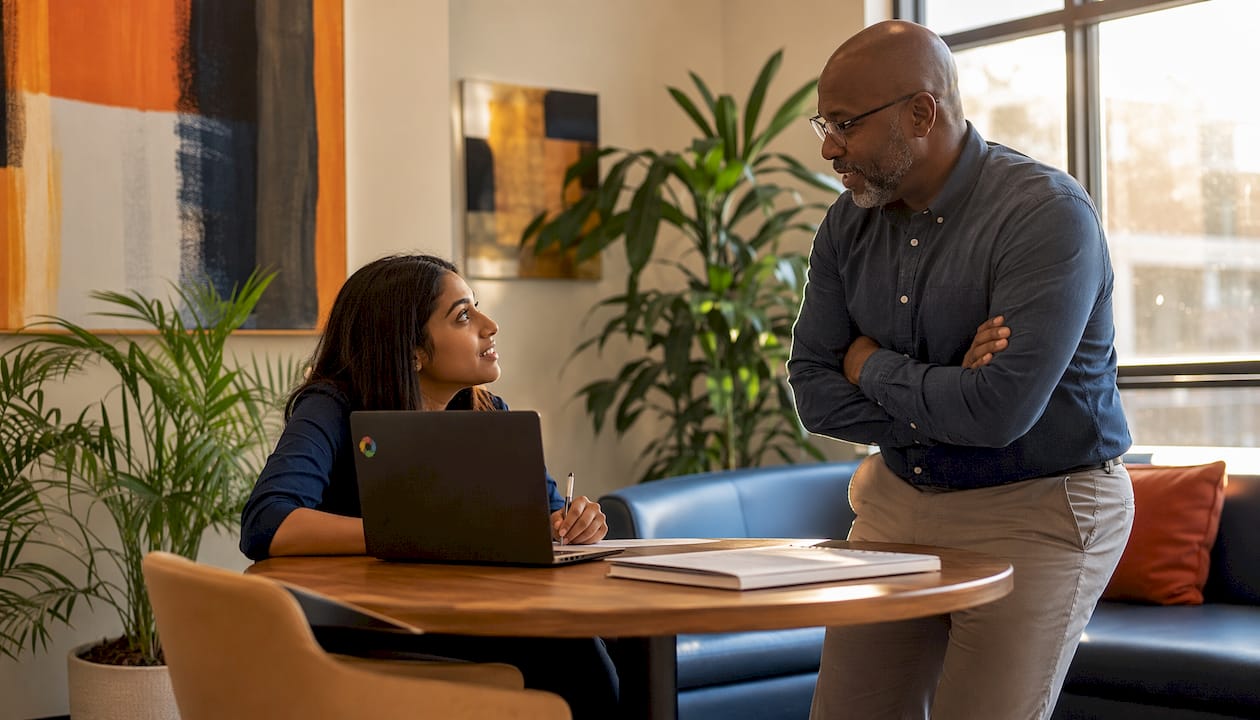 Manager coaching employee in office