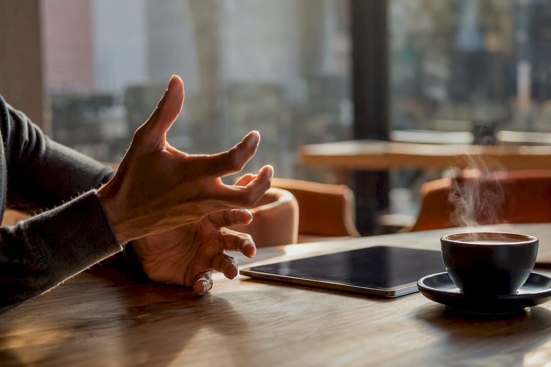 Hands gesturing energetically during discussion