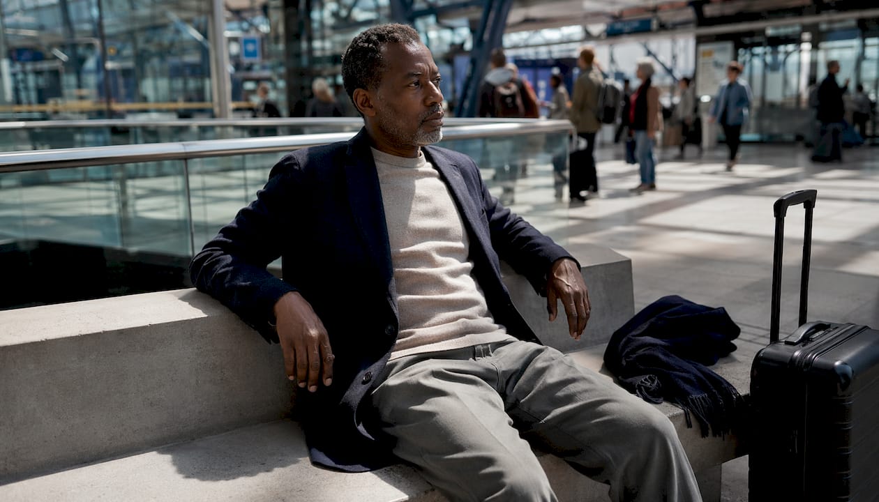 Man wearing breathable fabric layers waiting in airport