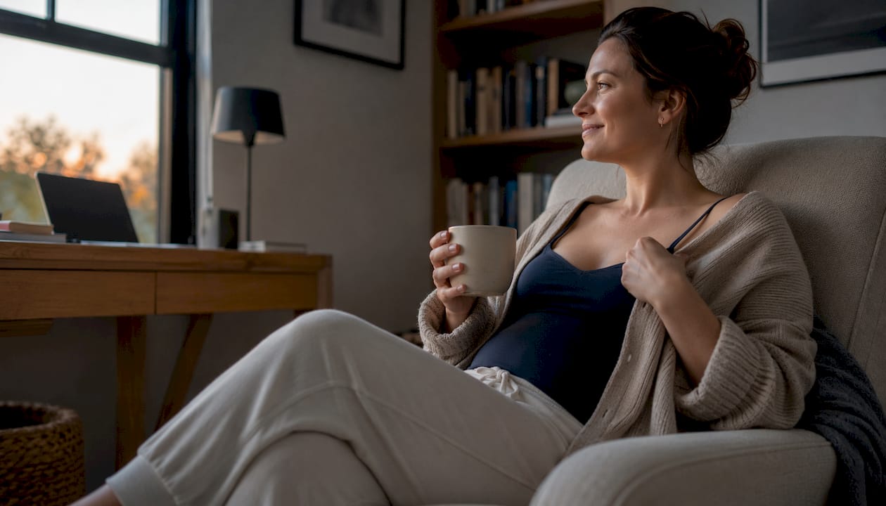 Woman in postpartum loungewear on sofa