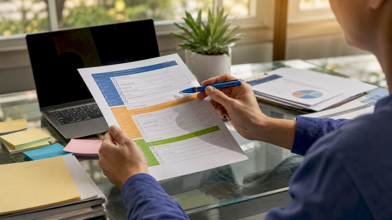 Hands examining operational capabilities checklist