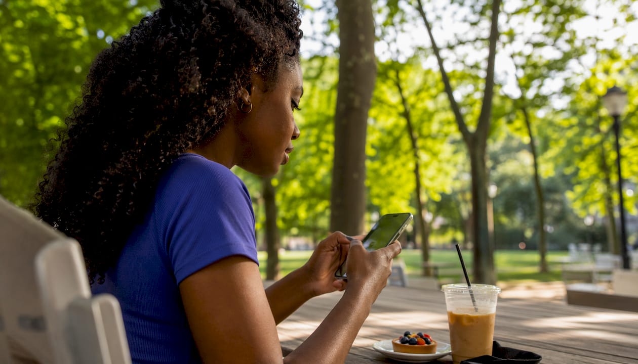 Woman viewing personalized local promotions on smartphone