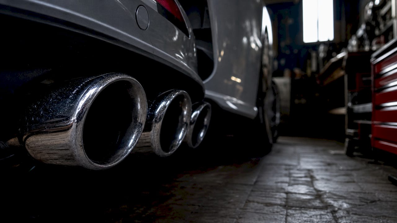 Close-up of V8 car exhaust pipes outdoors