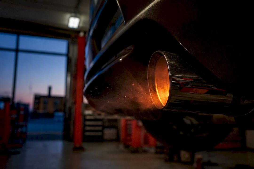 Glowing exhaust pipe tip igniting fuel