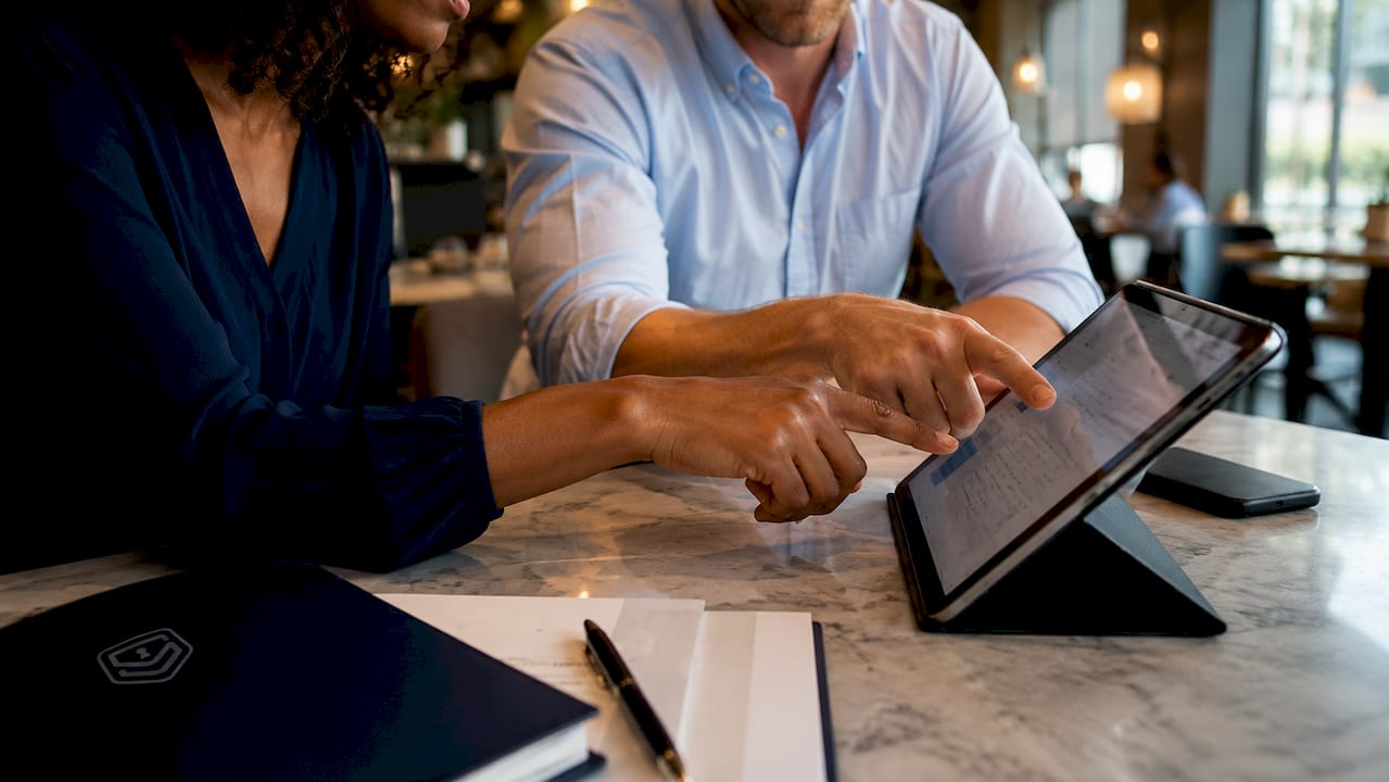 Hands pointing at digital asset inventory tablet