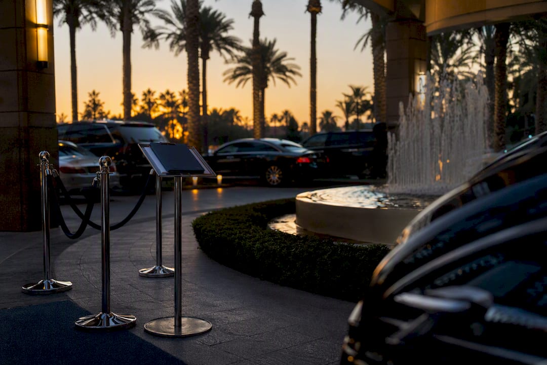 Luxury vehicle staging area at venue dusk