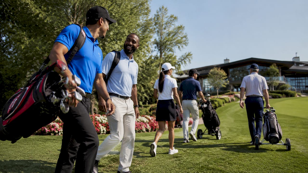 Group walking at local golf qualifying event