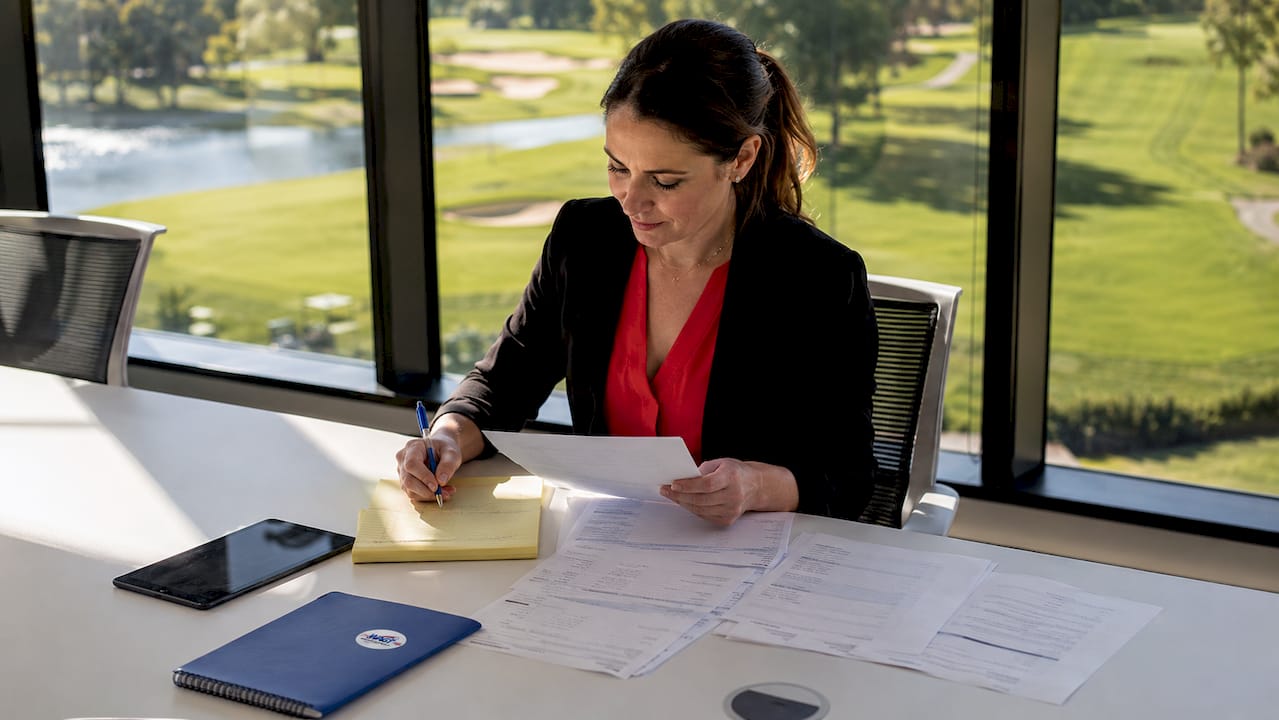 Golf course manager reviewing player feedback forms