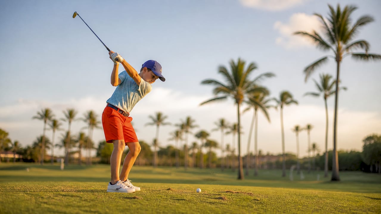 Junior golfer practicing swing outdoors
