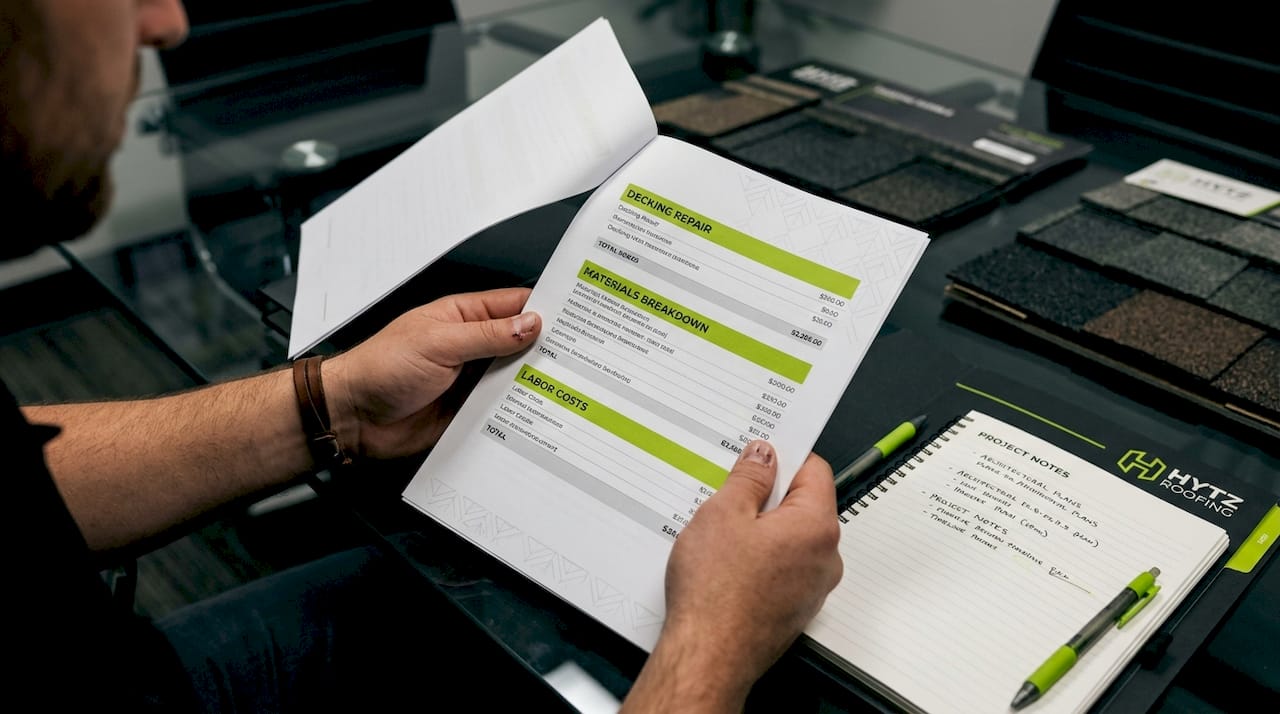 Close-up of itemized roofing bid and contractor license check