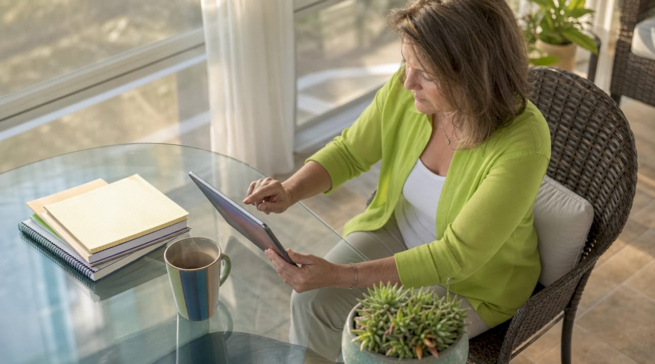 Woman reviewing roofing contractor reviews on tablet