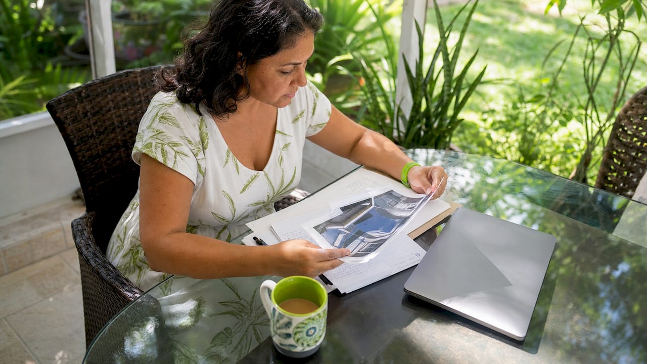 Homeowner checking roofing contractor documents