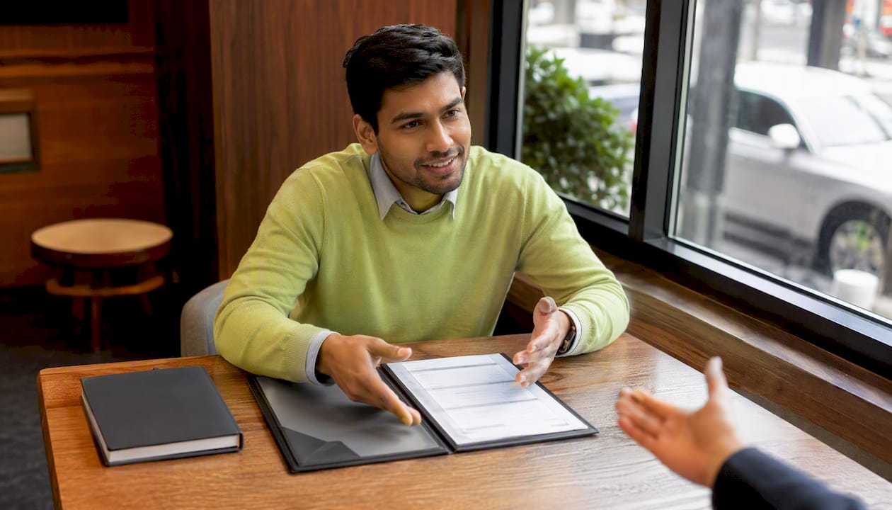 Client consulting bank loan officer indoors