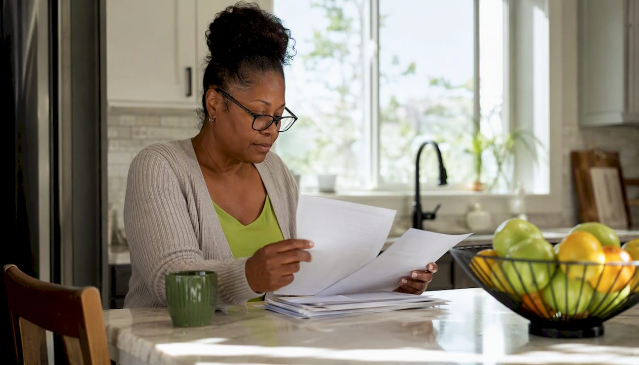 Homeowner reviewing roofing loan documents at desk