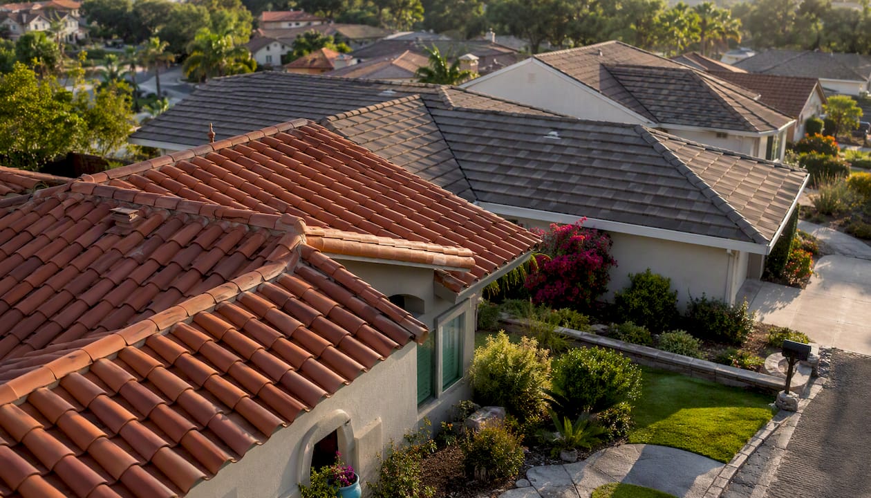 Aerial view of diverse tile roof styles in neighborhood