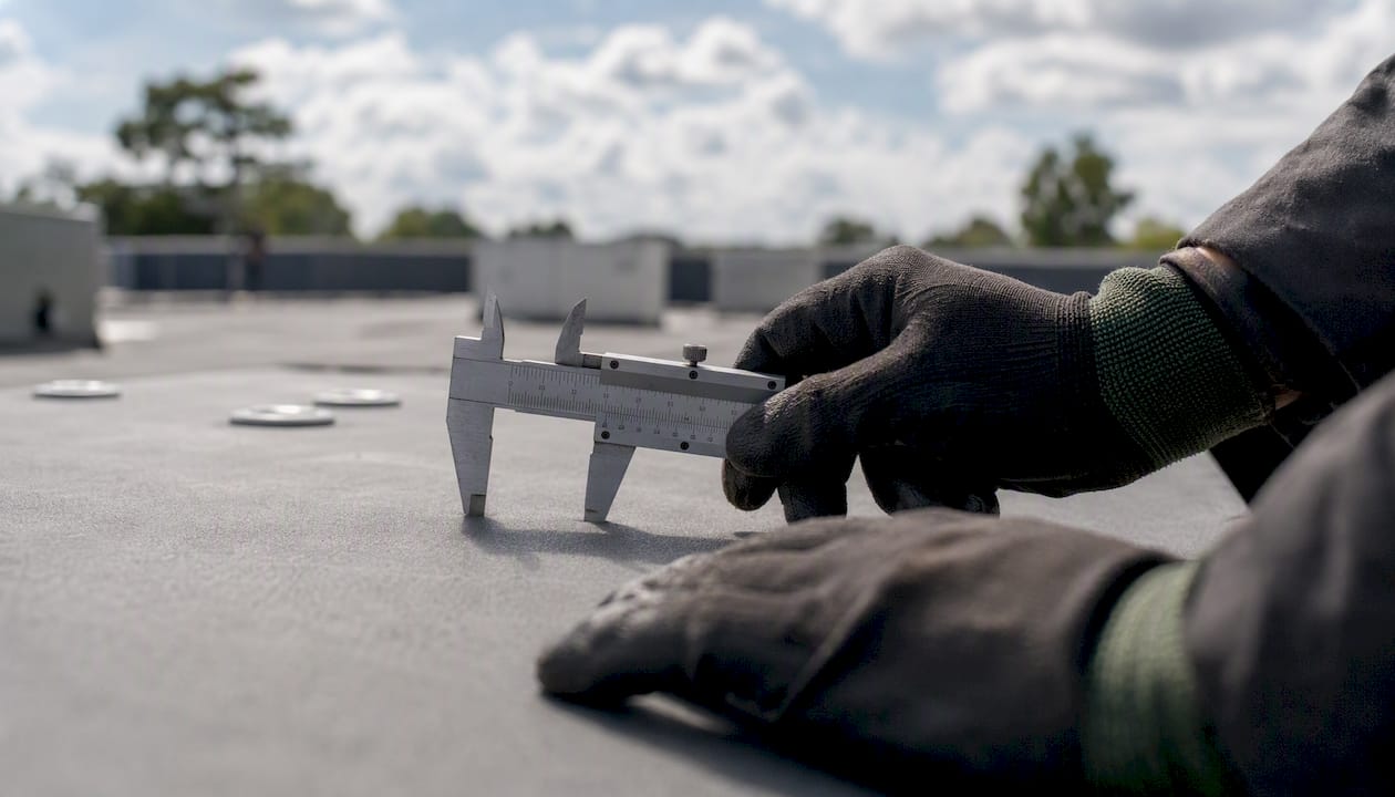 Caliper measuring roofing membrane thickness